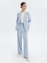a lady in blue triacetate loose fitting bazer with pants